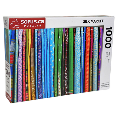 Isometric puzzle box of multicolored and patterned woven Silks at Market 1000 piece jigsaw puzzle by Sorus Puzzles